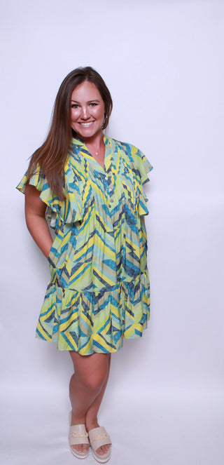 Printed flutter sleeve mini dress featuring pocket at sides.