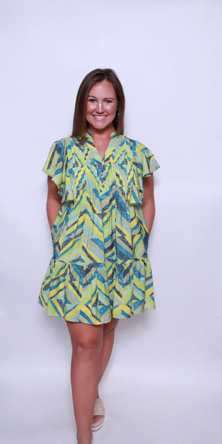 Printed flutter sleeve mini dress featuring pocket at sides.