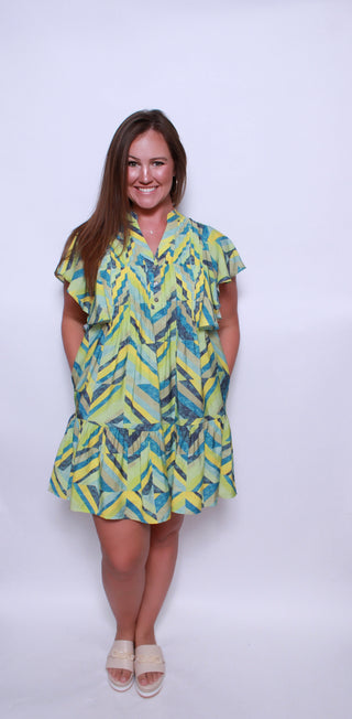 Printed flutter sleeve mini dress featuring pocket at sides.