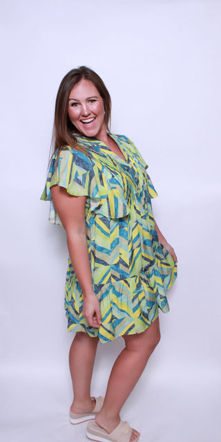 Printed flutter sleeve mini dress featuring pocket at sides.