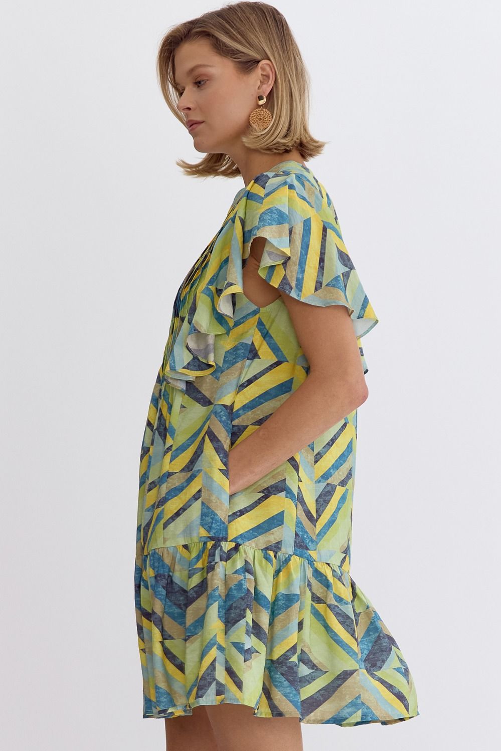 Printed flutter sleeve mini dress featuring pocket at sides.