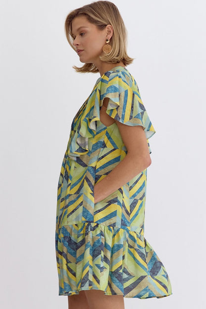 Printed flutter sleeve mini dress featuring pocket at sides.